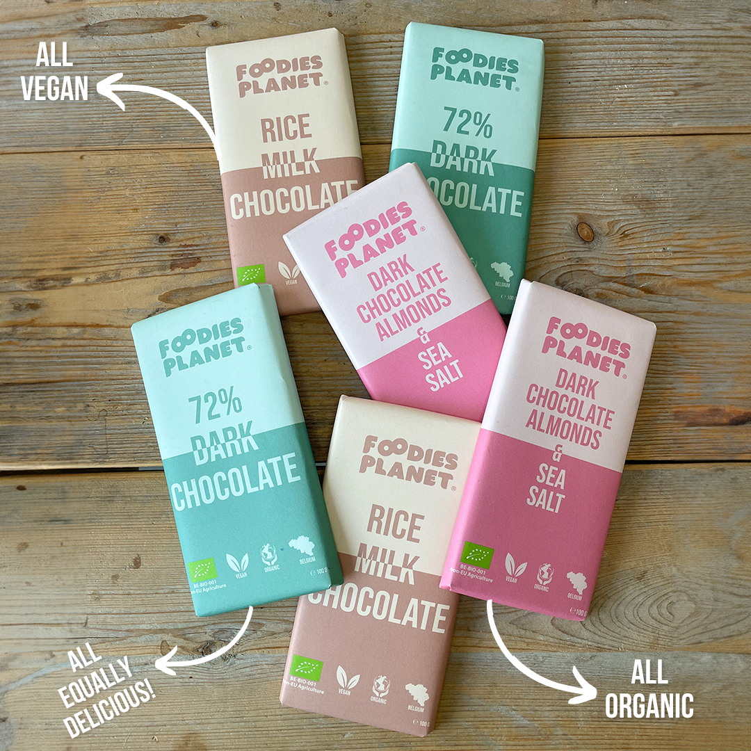 Chocolate bars from FOODIES-PLANET displayed on a table. All chocolate bars are vegan, organic and equally delicious.